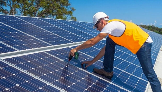 man repairing solar panel